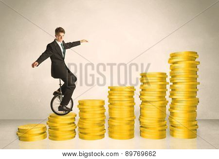 Business man riding monocycle up on coin graph concept on background