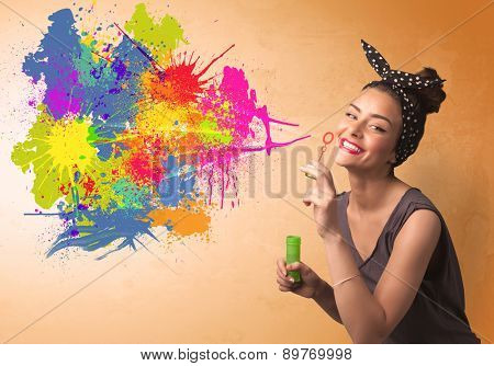 Cute girl blowing bubble spalsh graffiti into wall