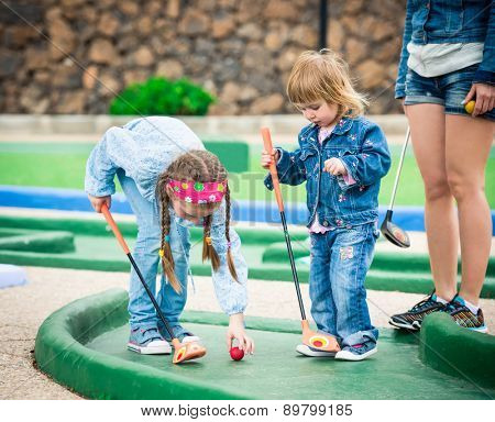Kids playing golf on a golf course