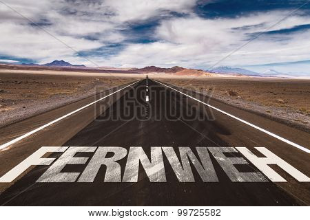 Wanderlust (in German) written on desert road