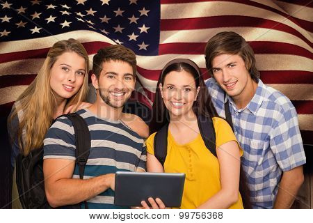 Students using digital tablet at college corridor against composite image of digitally generated united states national flag