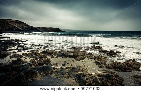 seawaves on a rocky shore at magnificent dusk