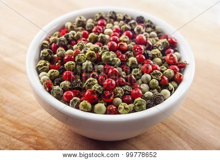 Mix of different peppers balls in white ceramic bowl
