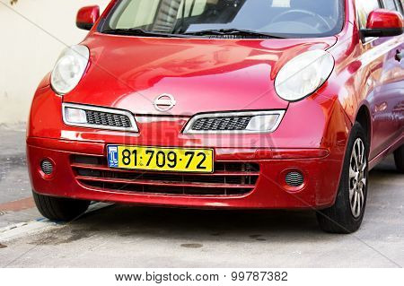 Tel - Aviv, Israel - March 29, 2015: Red Nissan Micra parked in Tel - Aviv.