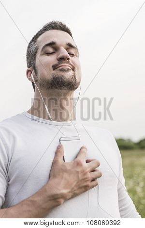 Happy young man in a field