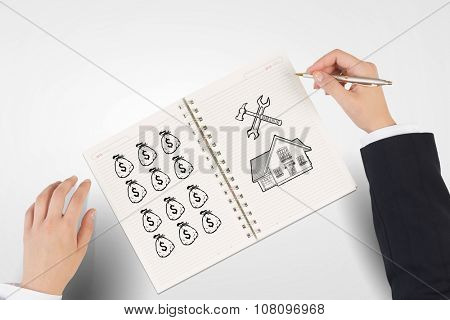 Businessman hands drawing money making formula in notepad