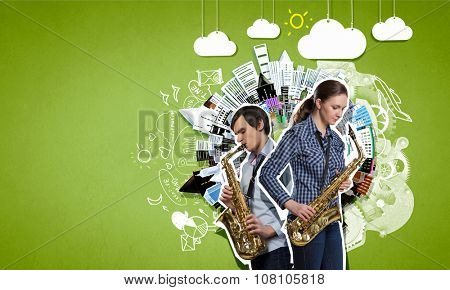 Duet of young man and woman musicians playing saxophones