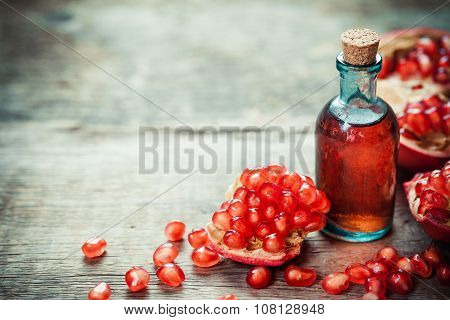 Pomegranate Tincture Or  Juice And Red Ripe Garnet Fruit With Seeds On Wooden Table.