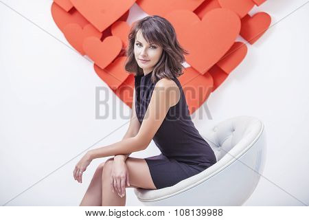 Portrait Of A Woman In A Black Bodycon Dress In White Modern Chair