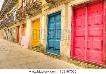 Colorful Worn Painted Doors Along Street In Portugal - Artistic Concept - Warm Filter Look