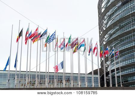 STRASBOURG FRANCE - 14 Nov 2015: European Union Flags and France flag flies at half-mast in front of the European Parliament building following an terrorist attack in Paris