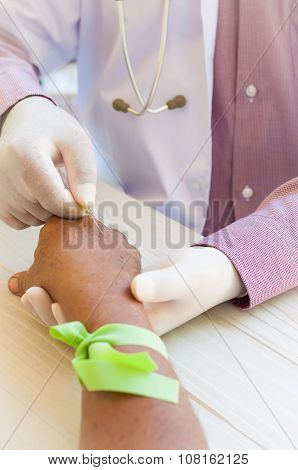 Close-up Of Doctor's Hand With Iv Drip Inserted In Patient's Hand