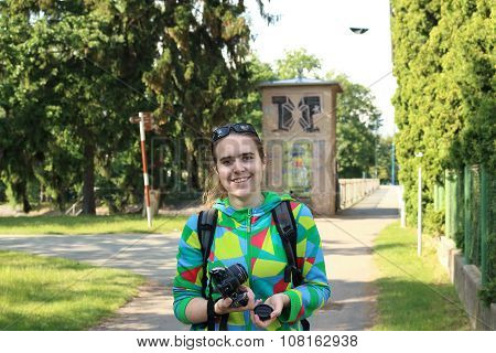 Smiling Girl Holding Camera On Pedestrian Zone In Podebrady