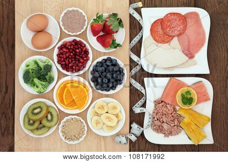 High protein super food diet of meat, fish and eggs, with fruit, vegetable and acai berry and maca supplement powder with tape measure. Also eaten by body builders.