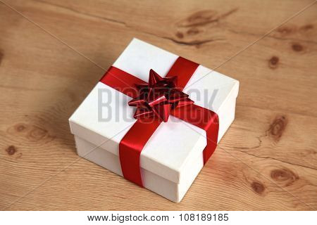 New Year gift on a golden tinsel background boly