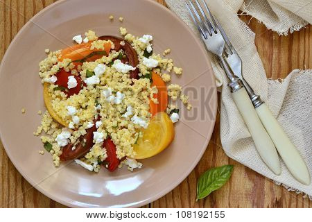 Millet with basil and fresh tomatoes and goat cheese