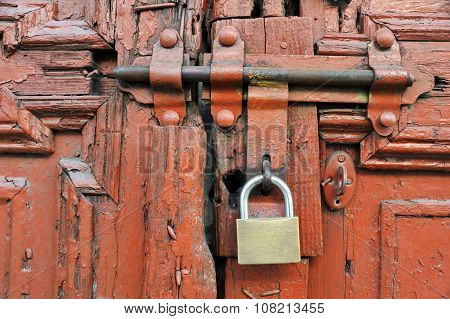 New lock on the old red cracked door with latch