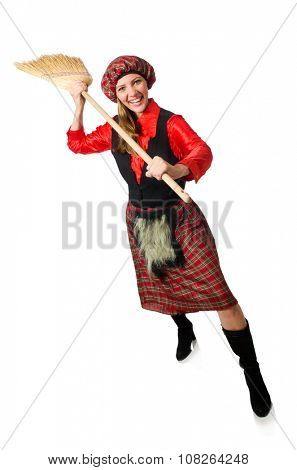 Funny woman in scottish clothing with broom