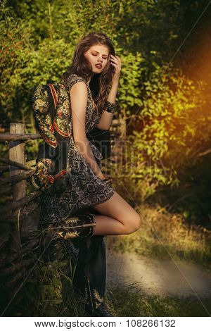 Beautiful young woman in fashion dress with makeup