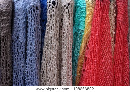 Colorful  lacy pullovers on hangers. Ladies' wear