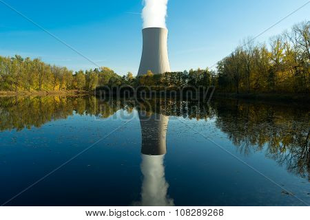 Nuclear Power Plant Next The Pond And Its Reflection In Water