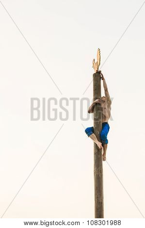 GOMEL, BELARUS - February 21, 2014: Young man climbs on a wooden