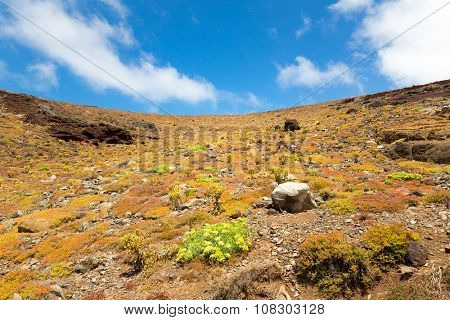 Rocky sandy hills against clear blue sky