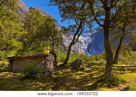 Old house near Briksdal glacier - nature and travel background