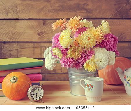 Still Life With Chrysanthemums, Pumpkins, Ware, Books And An Alarm Clock.