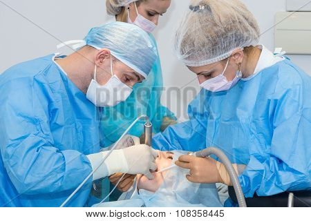 Dentists during surgery for implant placement