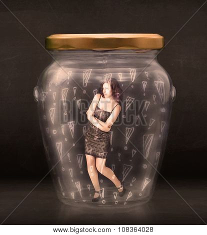 Business woman trapped in jar with exclamation marks concept on bakcground