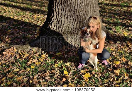 Happy Woman Kissing Her Dog