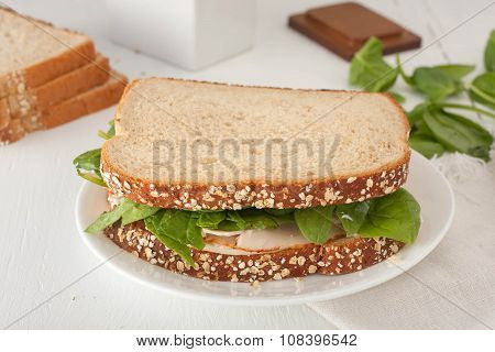 sandwich with mayonaisse, turkey, cheese and fresh spinach