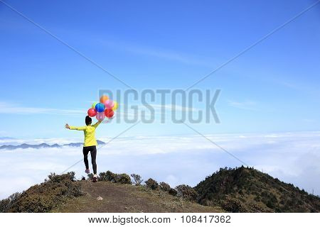 young woman with colorful balloons