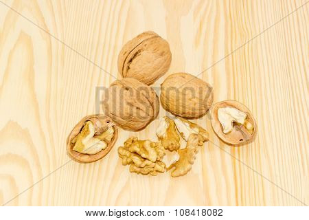Several Walnuts On A Wooden Surface