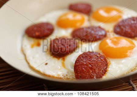 Fried eggs with sucuk in a frying pan