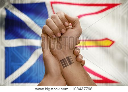Barcode Id Number On Wrist Of Dark Skin Person And Canadian Province Flag On Background - Newfoundla