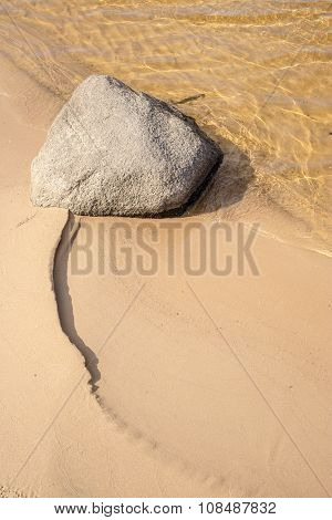 Lonely Stone Lies On The Sandy Beach