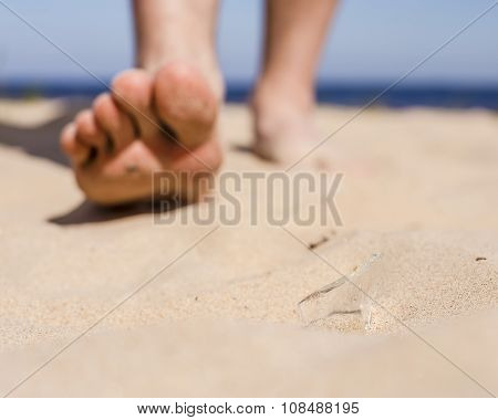 Man Goes On The Beach And The Risk Of Stepping On A Splinter Of Broken Bottle Glass