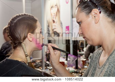 ZAGREB, CROATIA - OCTOBER 31, 2015: Fashion model undergoing makeup process in backstage for Couture show by Marina Design on the 'Fashion.hr' fashion show