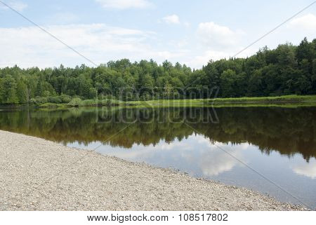 lake and trees gravel beach