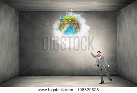 Businessman catch Earth planet with rope . Elements of this image are furnished by NASA