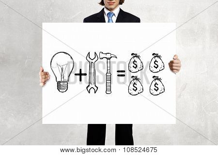Businessman holding banner with drawn money earning concept