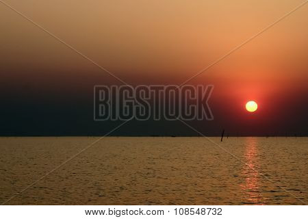 Sunset in the ocean with golden sky