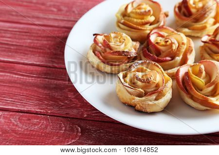 Fresh Puff Pastry With Apple Shaped Roses On Red Wooden Table