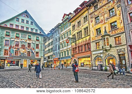 LUCERNE SWITZERLAND - JANUARY 04 2015: Historical buildings with frescos on the right bank of the River Reuss at picturesque square Muhlenplatz in Lucerne Switzerland
