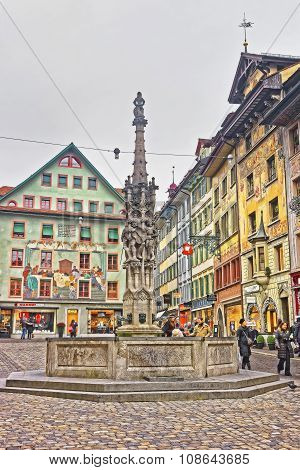 LUCERNE SWITZERLAND - JANUARY 04 2015: Weinmarkt fountain and decorated buildings at the Muhlenplatz square in Old Town of Lucerne Switzerland