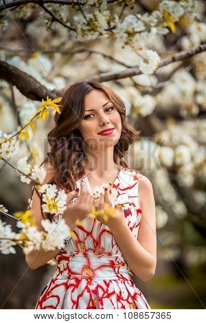 Beautiful young  brunette woman in spring garden