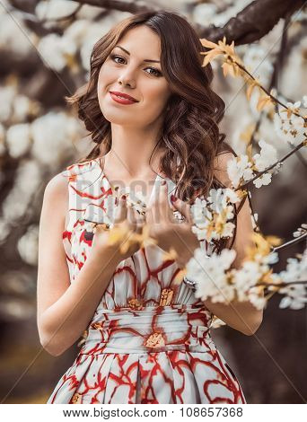 Beautiful young  brunette woman in spring garden