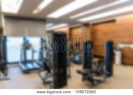 Abstract blur Fitness center with traineger equipments